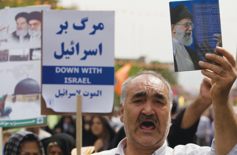  AN ANTI-ISRAEL demonstration takes place in Tehran. As Iran’s ayatollahs called from their pulpits for the destruction of Israel, it was easy for the West to forget that it too was in the line of fire, says the writer. (photo credit: REUTERS/CAREN FIROUZ)