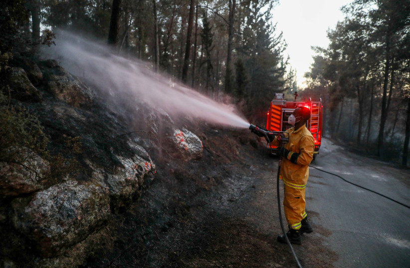  Firefighters try to extinguish a forest fire which broke near Beit Shemesh, on August 25, 2022. (credit: OREN BEN HAKOON/FLASH90)