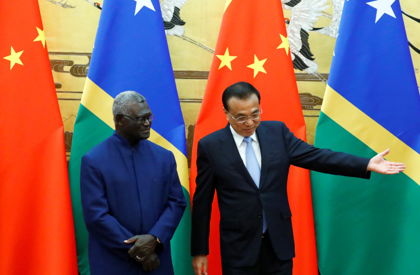  Solomon Islands Prime Minister Manasseh Sogavare and Chinese Premier Li Keqiang attend a signing ceremony at the Great Hall of the People in Beijing, China October 9, 2019.  (photo credit: THOMAS PETER/REUTERS)