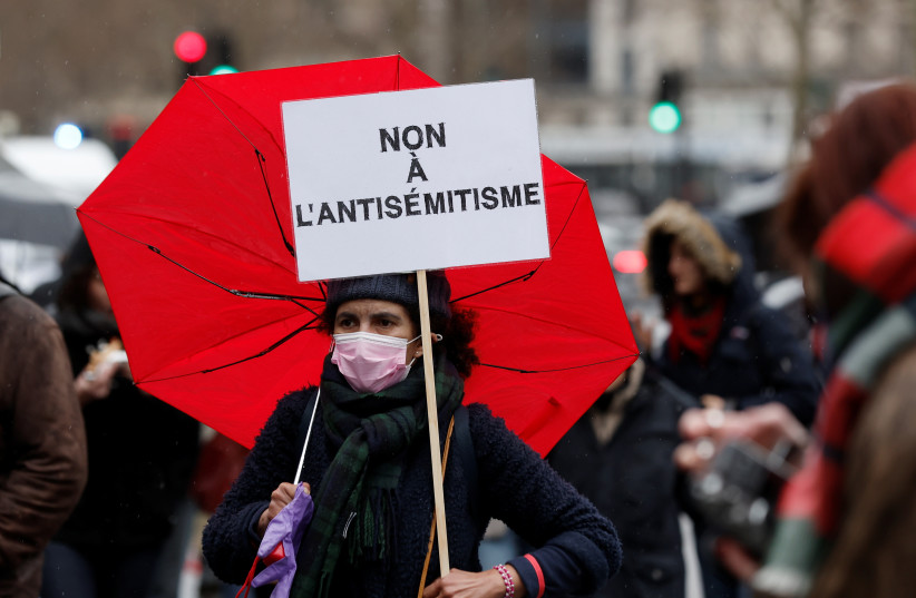  A demonstrator holds a sign that reads 'no to antisemitism', during a protest against antisemitism and to commemorate the 2012 Toulouse attack against a Jewish school that left three children and an adult dead, at the Place de la Republique square in Paris, France, March 13, 2022.  (photo credit: REUTERS/BENOIT TESSIER)