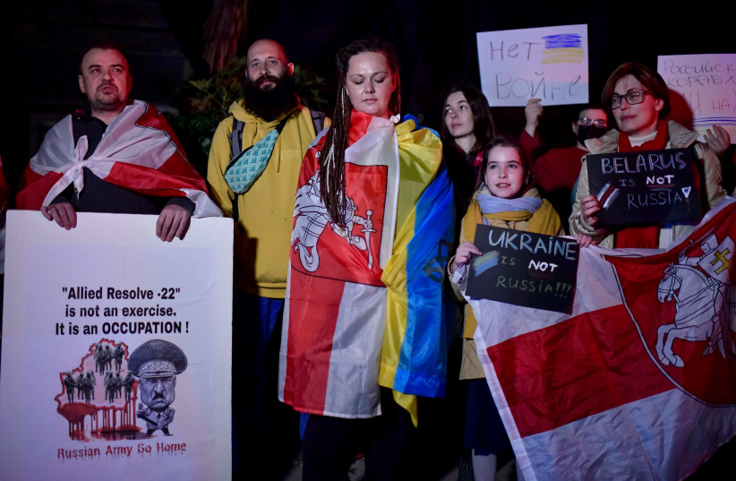  Demonstrators carry placards and flags during a protest protest against Belarusian President Alexander Lukashenko, outside Belarus embassy in Tel Aviv, on February 27, 2022 (credit: TOMER NEUBERG/FLASH90)
