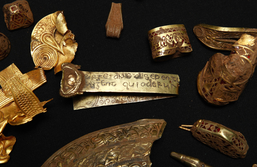  A strip of gold bearing a Biblical inscription is seen amongst a hoard of Anglo-Saxon treasure named 'The Staffordshire Hoard' in Birmingham, central England (credit:  REUTERS/ Eddie Keogh)