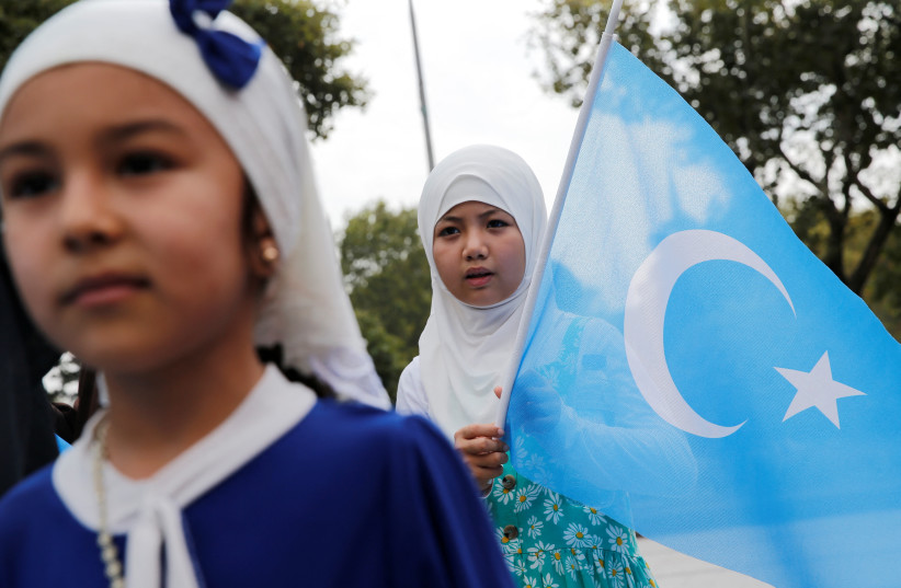  An ethnic Uyghur girl holds an East Turkestan flag during a protest against China, in Istanbul, Turkey August 31, 2022. (credit: REUTERS/DILARA SENKAYA)