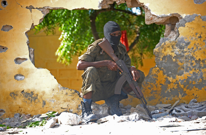  A SOMALI soldier stands guard next to the site where al-Shabaab terrorists carried out a suicide attack against a military intelligence base in Mogadishu, 2015.  (credit: Mohamed Abdiwahab/AFP via Getty Images)