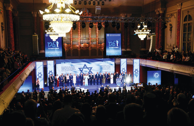  PARTICIPANTS SING ‘Hatikvah’ at the end of a gala event on occasion of the 125th anniversary of the First Zionist Congress at the original venue, the Stadtcasino Basel, in Basel, Switzerland, on Monday.  (photo credit: ARND WIEGMANN / REUTERS)