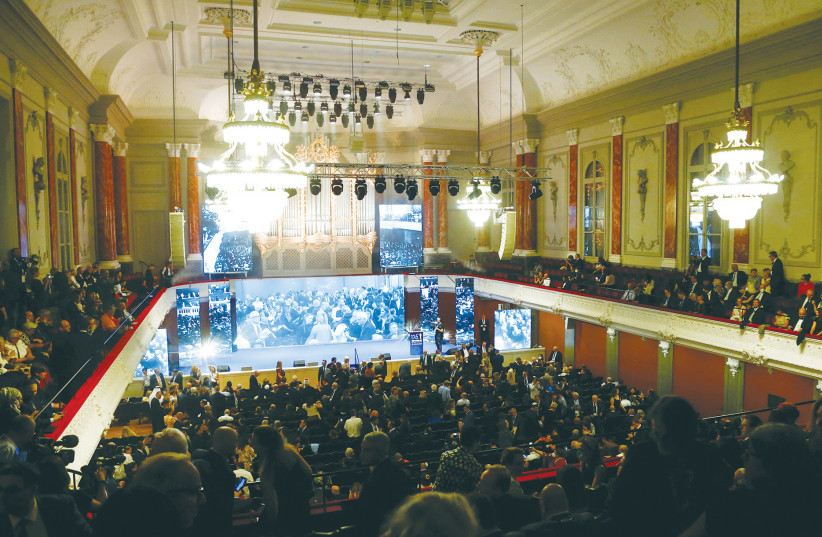  ATTENDEES ARRIVE for the conference on the occasion of the 125th anniversary of the First Zionist Congress at the original venue, the Stadtcasino Basel, in Switzerland this week.  (photo credit: ARND WIEGMANN / REUTERS)