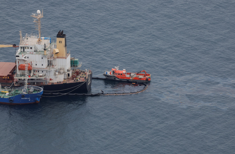  Oil leaks from cargo ship OS 35 which remains half sunken in Catalan Bay after its collision with an LNG tanker off Gibraltar, September 1, 2022. (photo credit: REUTERS/JON NAZCA)