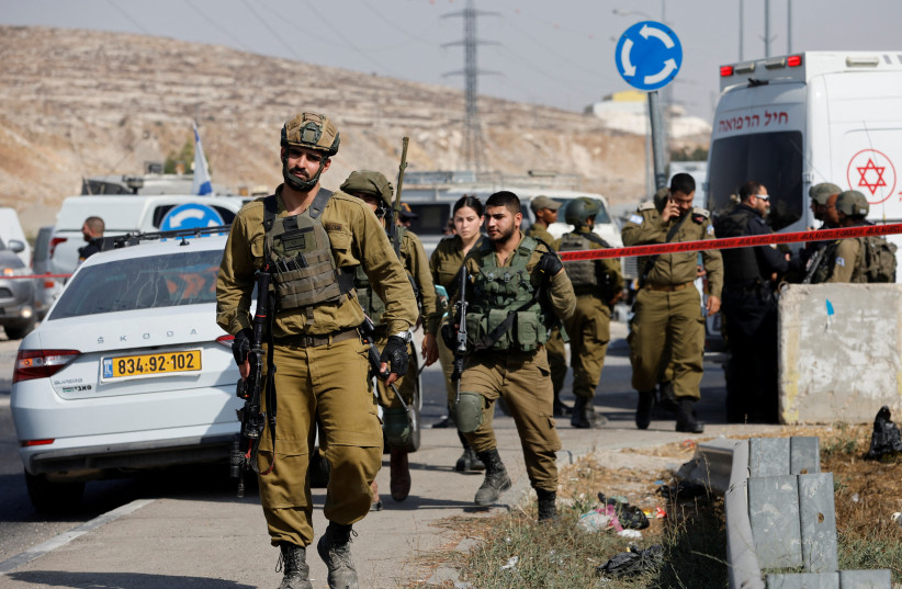  Israeli troops walk near a scene of stabbing incident near Hebron, in the West Bank, September 2, 2022. (photo credit: MUSSA ISSA QAWASMA/REUTERS)