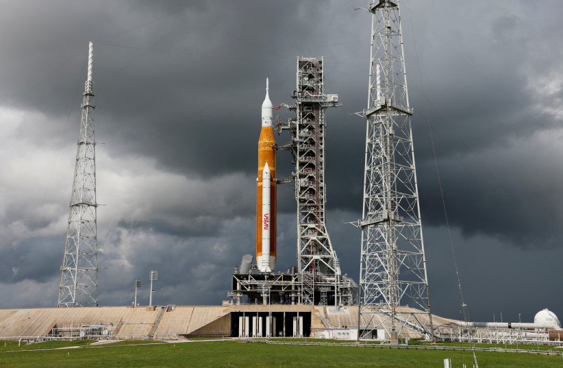  NASA's next-generation moon rocket, the Space Launch System (SLS) with the Orion crew capsule perched on top, stands on launch complex 39B as rain clouds move into the area before its rescheduled debut test launch for the Artemis 1 mission at Cape Canaveral, Florida, US September 2, 2022.  (photo credit: REUTERS/JOE SKIPPER)