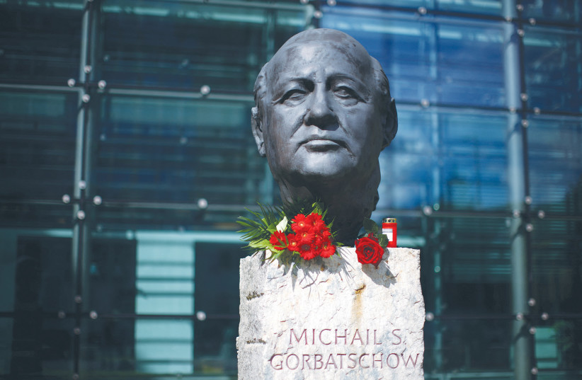  ROSES ARE placed on a sculpture of Mikhail Gorbachev in memory of the final leader of the Soviet Union, at the ‘Fathers of Unity’ memorial in Berlin, on Wednesday.  (credit: Lisi Niesner/Reuters)