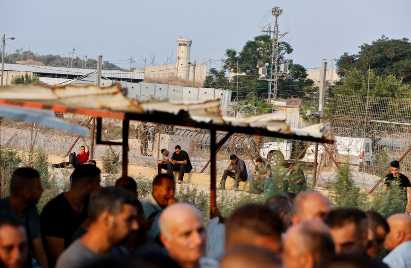  Palestinian workers in Israel strike against Israel and Palestinian Authority's recent agreement to have their wages transferred to bank accounts, at an Israeli checkpoint in Tulkarm in the West Bank, August 21, 2022. (photo credit: REUTERS/RANEEN SAWAFTA)
