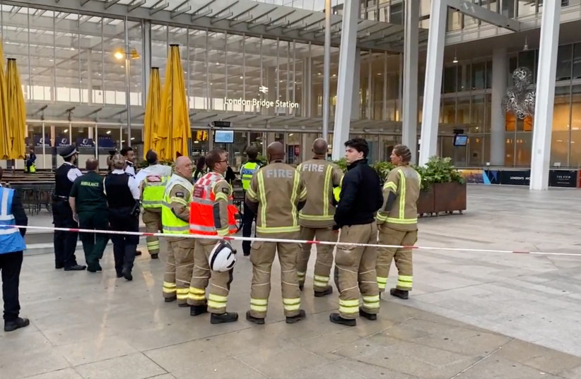 Emergency responders stand at the bottom of the building as two free climbers go up the Shard, in London, Britain, September 4, 2022 in this screengrab obtained from a social media video. (credit: JAMES J. MARLOW VIA REUTERS)
