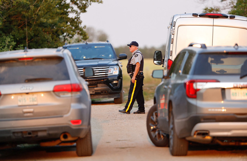 A Royal Canadian Mounted Police (RCMP) officer arrives at a crime scene after multiple people were killed and injured in a stabbing spree in Weldon, Saskatchewan, Canada, September 4, 2022. (photo credit: REUTERS/DAVID STOBBE)