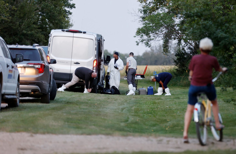 A police forensics team investigates a crime scene after multiple people were killed and injured in a stabbing spree in Weldon, Saskatchewan, Canada, September 4, 2022. (credit: REUTERS/DAVID STOBBE)