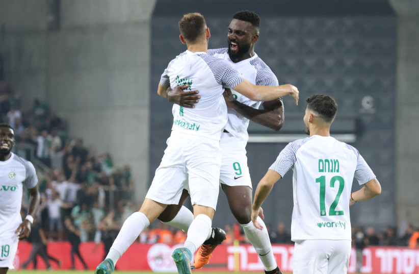 Maccabi Haifa teammates Frantzdy Pierrot (9) and Omer Atzily celebrate after hooking up for the game-winning goal in the Greens’ 2-1 victory over Hapoel Beersheba ahead of tonight’s opening Champions League group stage showdown in Portugal against Benfica. (credit: DANNY MARON)