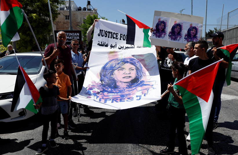 Palestinians protest in support of slain Palestinian-American journalist Shireen Abu Akleh, as US President Joe Biden visits Augusta Victoria Hospital, in Jerusalem, July 15, 2022. (credit: REUTERS/AMMAR AWAD)