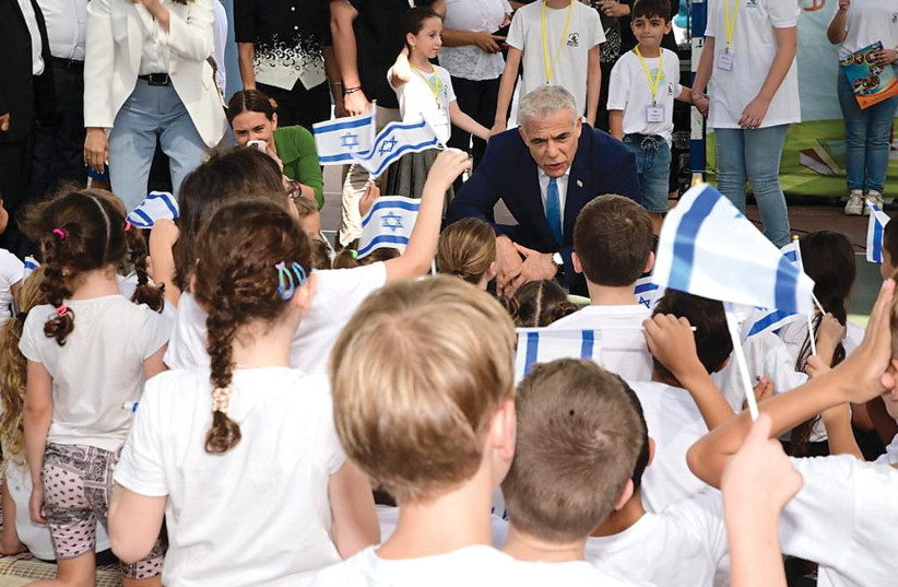  Israeli Prime Minister Yair Lapid meets schoolchildren on the first day of the Israeli school year, September 1, 2022. (photo credit: AVSHALOM SASSONI)