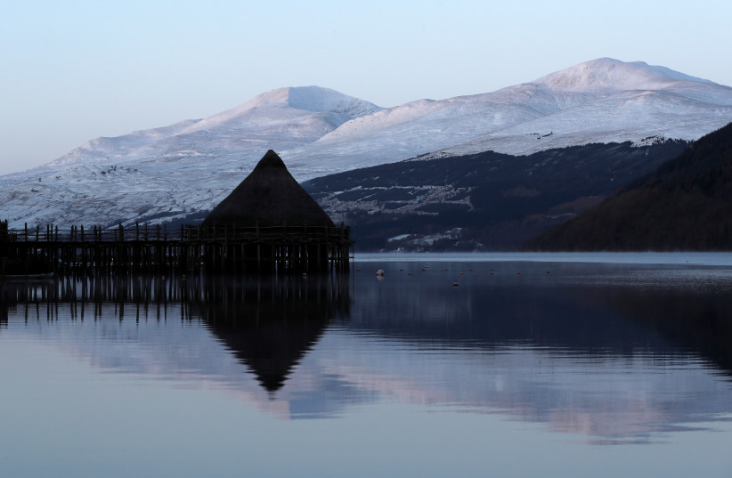  The Crannog Centre is reflected in Loch Tay in Perthshire, Scotland, Britain (photo credit: REUTERS)