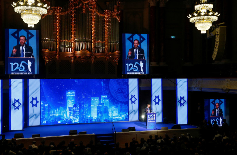 Israeli President Isaac Herzog addresses a gala event on occasion of the 125th anniversary of the First Zionist Congress at the original venue, the Stadtcasino Basel, in Basel, Switzerland August 29, 2022 (credit: REUTERS/ARND WIEGMANN)
