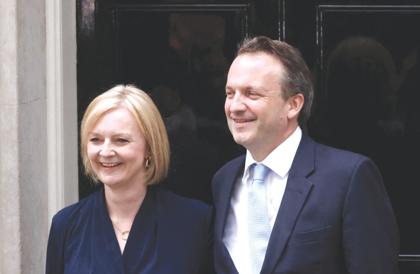  NEW BRITISH Prime Minister Liz Truss and her husband Hugh O'Leary stand outside 10 Downing Street on Tuesday. (photo credit: HENRY NICHOLLS/REUTERS)