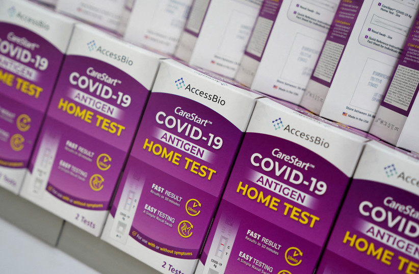 COVID-19 home test kits are pictured in a store window during the coronavirus disease (COVID-19) pandemic in the Manhattan borough of New York City, New York, US, January 19, 2022. (photo credit: REUTERS/CARLO ALLEGRI/FILE PHOTO)