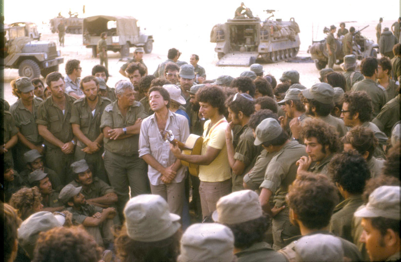  LEONARD COHEN entertaining weary IDF troops during the Yom Kippur War, accompanied on guitar by Israeli singer-songwriter Matti Caspi, with Gen. Ariel Sharon in close attendance. (photo credit: Doron Yaakovi)