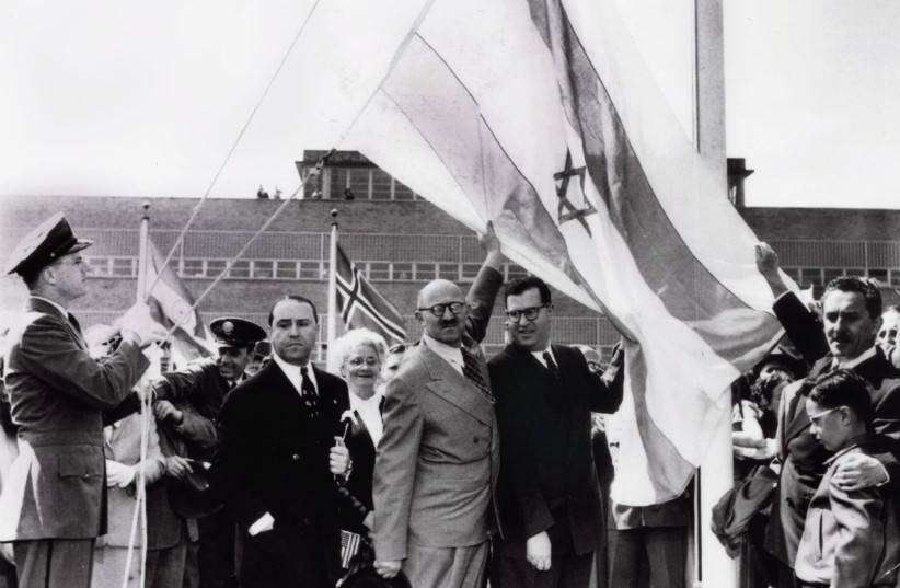  Abba Eban (center right) and David Hacohen (center left), later to be an Israeli member of parliament, raise the Israeli flag on top of the United Nations building soon after the November 29, 1947, Partition Plan vote. Eban once said that ‘the Jews are a people who refuse to take yes for an answer. (photo credit: REUTERS)