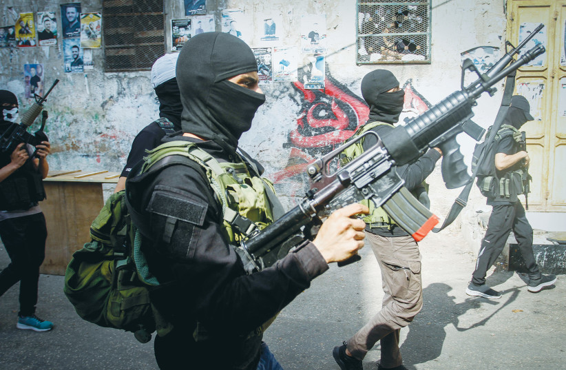  PALESTINIAN GUNMEN from al-Aqsa Martyrs Brigades hold a military parade in the Balata refugee camp, east of Nablus, last week. Israel need not apologize for defending itself against Palestinian terrorist cells, says the writer. (photo credit: NASSER ISHTAYEH/FLASH90)