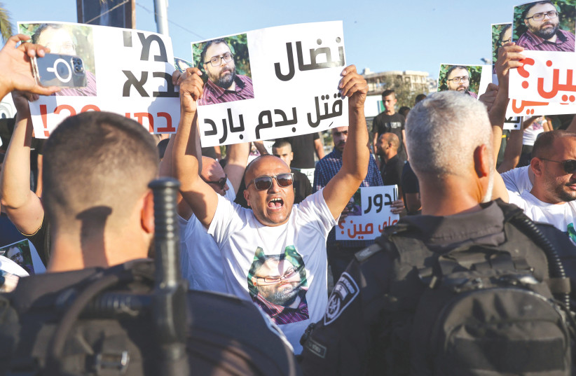  JOURNALISTS AND residents protest crime and violence, following the murder of Israeli-Arab journalist Nidal Aghbariya, at the entrance of the northern town of Umm el-Fahm on September 5. Aghbariya was killed in a criminal shooting.  (photo credit: Ahmad Gharabli/AFP via Getty Images)