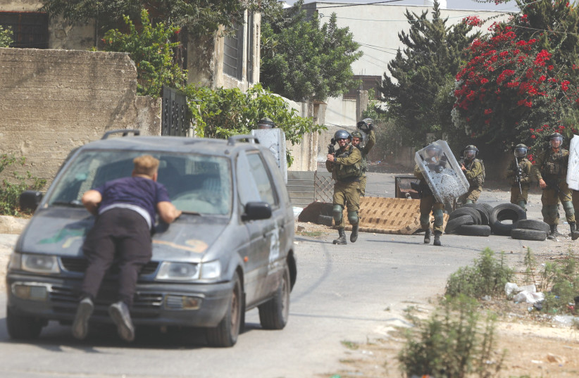  PALESTINIANS CLASH with Israeli security forces near the West Bank village of Kafr Kaddum last week. (photo credit: JAAFAR ASHTIYEH/AFP via Getty Images)