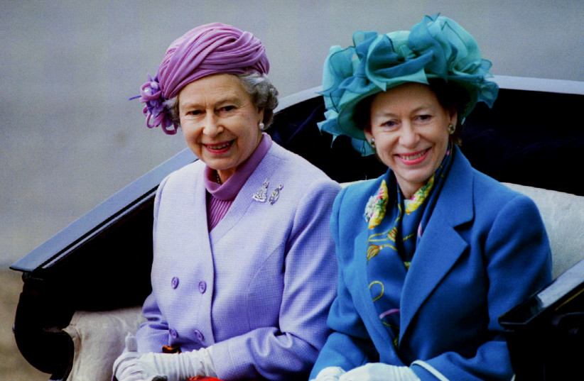 FILE PHOTO: Queen Elizabeth II and Princess Margaret travel in an open carriage during a ceremony at which the Queen, as Colonel in Chief of the Regiment, presented the new standards to the Household Cavalry in London.