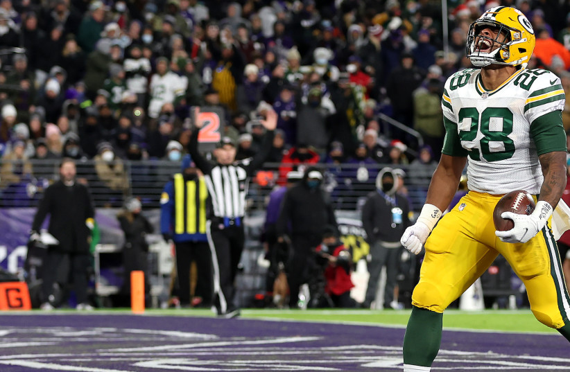  Running back A.J. Dillon of the Green Bay Packers celebrates after rushing for a first half touchdown against the Baltimore Ravens in Baltimore, Dec. 19, 2021.  (photo credit: Rob Carr/Getty Images)