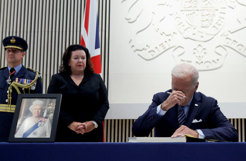  US President Joe Biden gestures as he signs a condolence book after Queen Elizabeth, Britain's longest-reigning monarch and the nation's figurehead for seven decades, died aged 96, at the British Embassy, in Washington, US, September 8, 2022. (photo credit: EVELYN HOCKSTEIN/REUTERS)