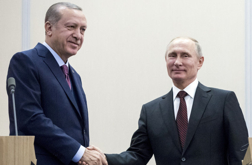 Russia's President Vladimir Putin (R) shakes hands with Turkey's President Tayyip Erdogan during a meeting in Sochi, Russia, November 13, 2017. (credit: REUTERS/PAVEL GOLOVKIN/POOL/FILE PHOTO)