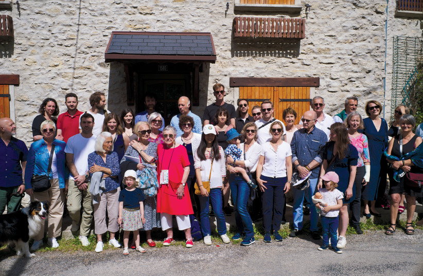  Some of the descendants of the Bitker family who joined the June reunion in the French town of Engins, where the family hid from the German army during World War II. In the center in red is Colette Bitker embracing Geneviėve Pannier, her neighbor 78 years ago. (credit: XAVIER CASSARD)