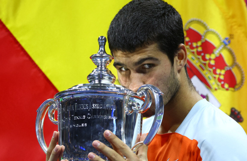  Spain's Carlos Alcaraz celebrates with the trophy after winning the US Open in Flushing Meadows, New York, United States - September 11, 2022.  (photo credit: Mike Segar/Reuters)