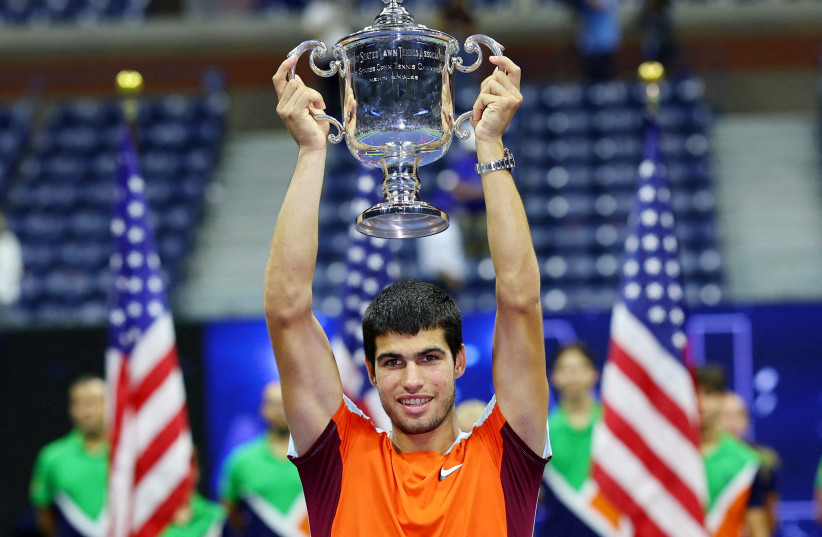  Spain's Carlos Alcaraz celebrates with the trophy after winning the US Open in Flushing Meadows, New York, United States - September 11, 2022.  (credit: Mike Segar/Reuters)