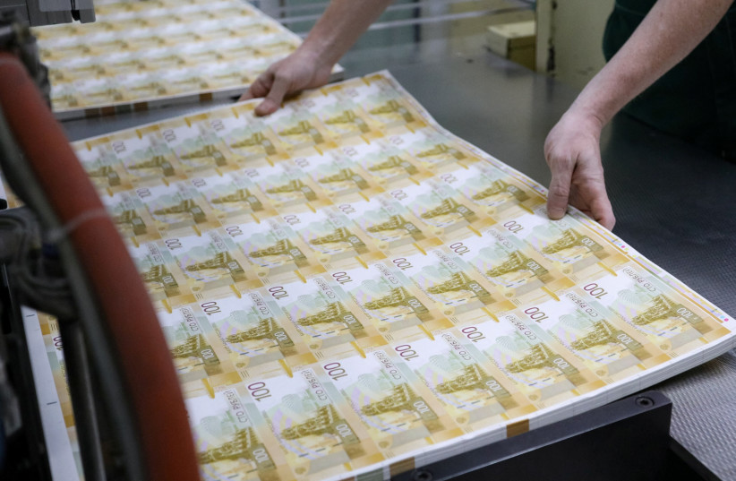  An employee holds sheets of the newly designed Russian 100-rouble banknotes at the Goznak printing factory in Moscow, Russia July 6, 2022.  (photo credit: MOSCOW NEWS AGENCY/HANDOUT VIA REUTERS)
