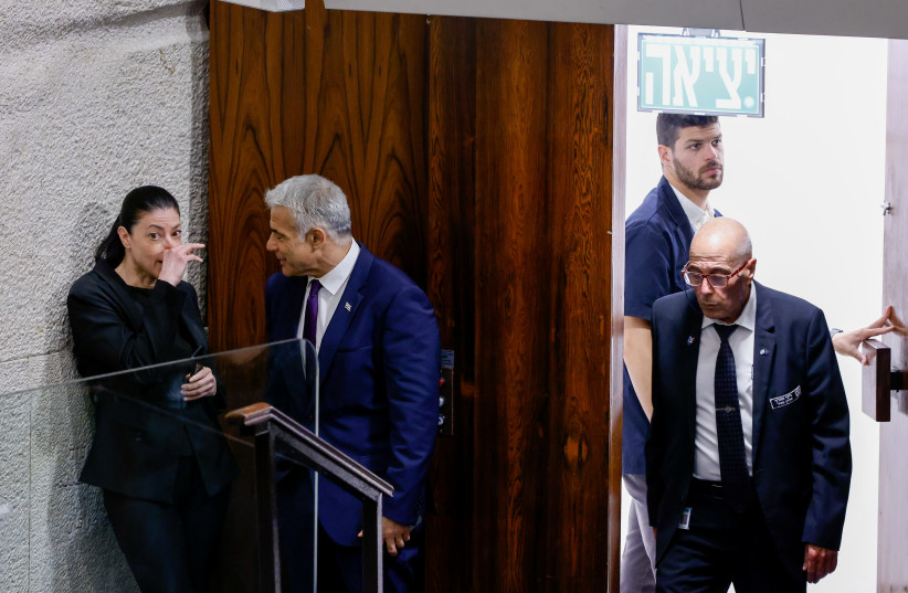  Foreign Minister Yair Lapid with Merav Michaeli, Minister of Transport and Road Safety during a discussion and a vote on a bill to dissolve the Knesset, at the assembly hall of the Israeli parliament, in Jerusalem, on June 22, 2022 (credit: OLIVIER FITOUSSI/FLASH90)