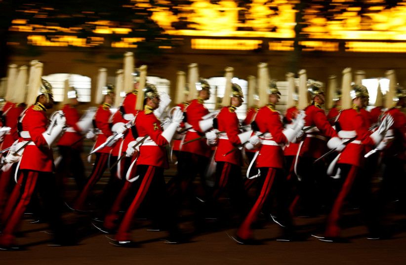  The cortege makes its way on The Mall in a nighttime rehearsal for when the coffin will be moved from Buckingham Palace to Westminster Hall, where Britain's Queen Elizabeth will lie in state for four days, following her death, in London, Britain September 13, 2022. (photo credit: REUTERS/SARAH MEYSSONNIER)