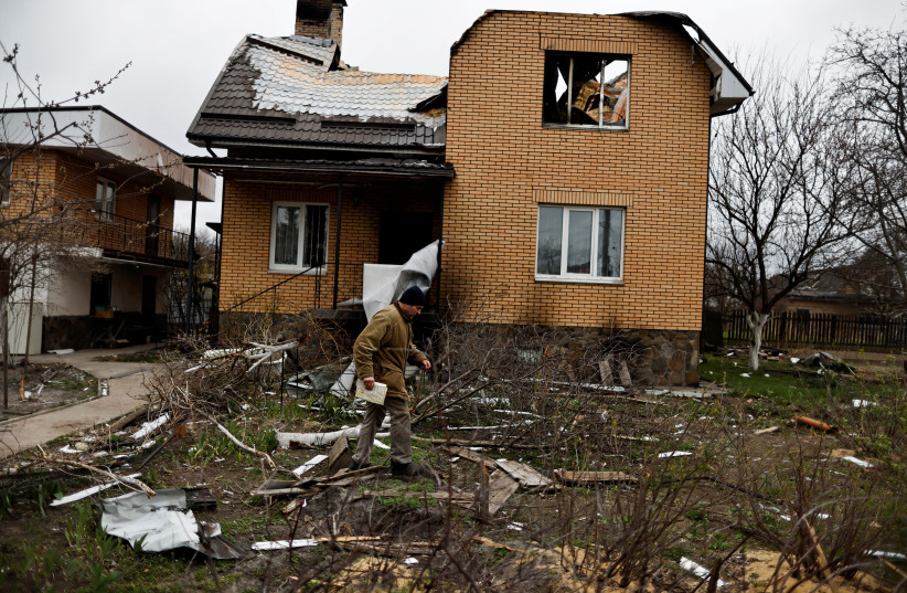 Vitalii Zhyvotovskyi, 50, walks outside his house that he told Reuters was destroyed by Russian troops as they were retreating from Bucha, in Bucha, Kyiv region, Ukraine, April 19, 2022. (credit: REUTERS/ZOHRA BENSEMRA/FILE PHOTO)