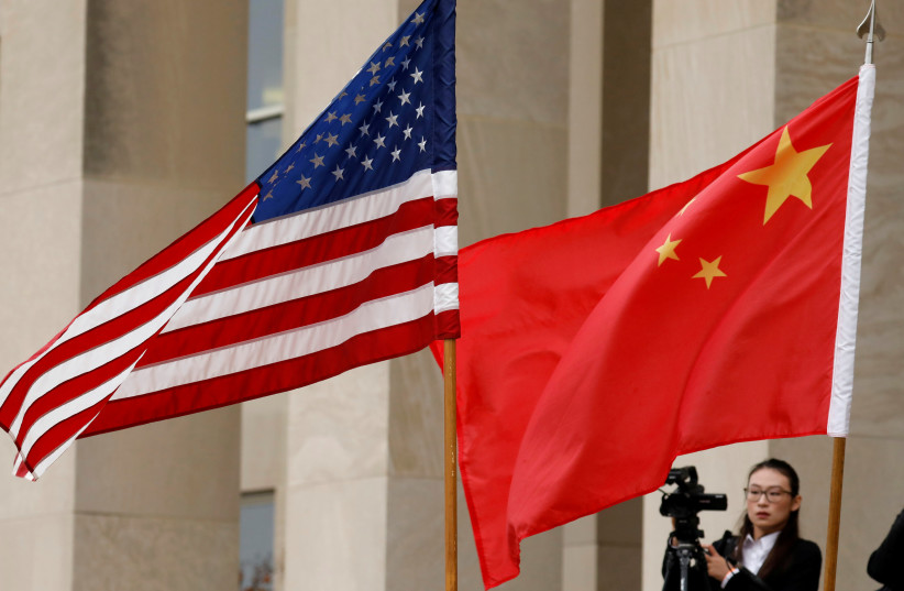 US and Chinese flags are seen before a meeting between senior defence officials from both countries at the Pentagon in Arlington, Virginia, US, November 9, 2018.  (photo credit: REUTERS/YURI GRIPAS/FILE PHOTO)