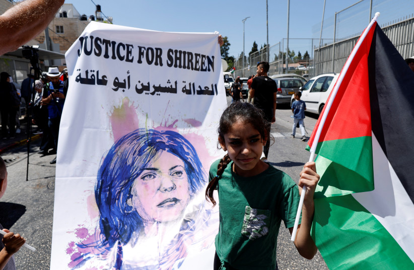  A Palestinian girl protests in support of slain Palestinian-American journalist Shireen Abu Akleh, as US President Joe Biden visits Augusta Victoria Hospital, in Jerusalem (photo credit: REUTERS/AMMAR AWAD)