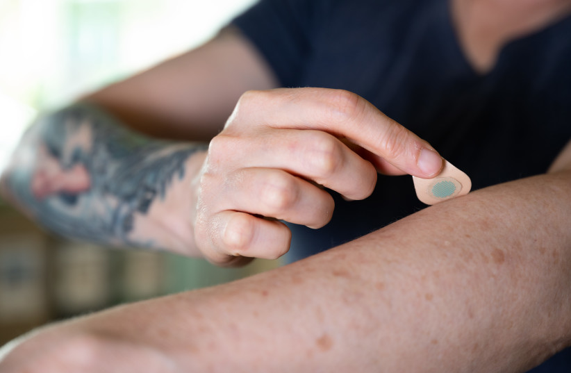  A microneedle patch tattoo is pressed to the skin. (photo credit: Georgia Tech)