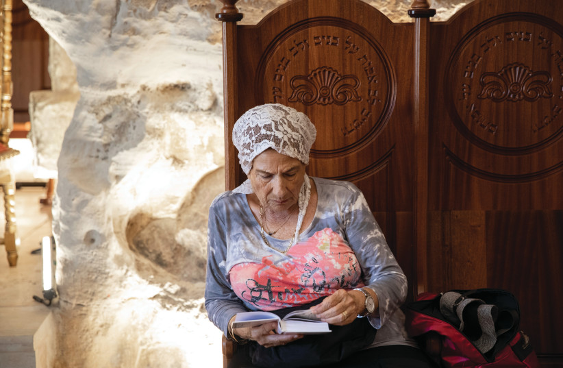  SERVICE OF the heart: Engaging in prayer in Elijah’s Cave, Haifa. (photo credit: SHIR TOREM/FLASH90)