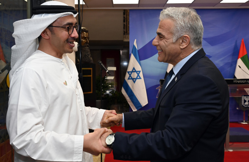  Prime Minister Lapid holding hands with UAE Foreign Minister Sheikh Abdullah bin Zayed Al Nahyan, September 15 2022. (credit: HAIM ZACH/GPO)