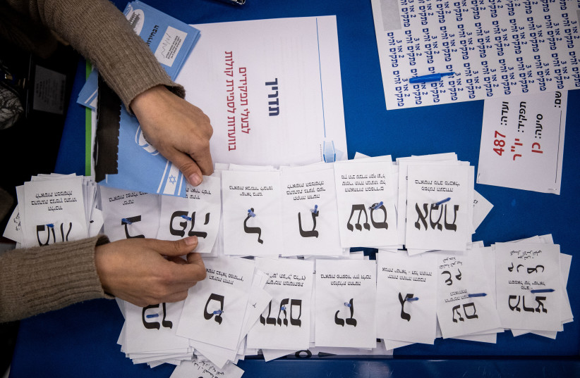  Central Election Committee workers count the remaining ballots at the Israeli parliament in Jerusalem,  after the general elections, on March 25, 2020.  (credit: YONATAN SINDEL/FLASH90)