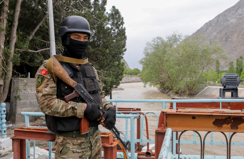  A service member of Kyrgyz special operations forces stands guard near Golovnoi water distribution facility outside the village of Kok-Tash in Batken province, Kyrgyzstan May 5, 2021. (photo credit: Vladimir Pirogov/REUTERS)