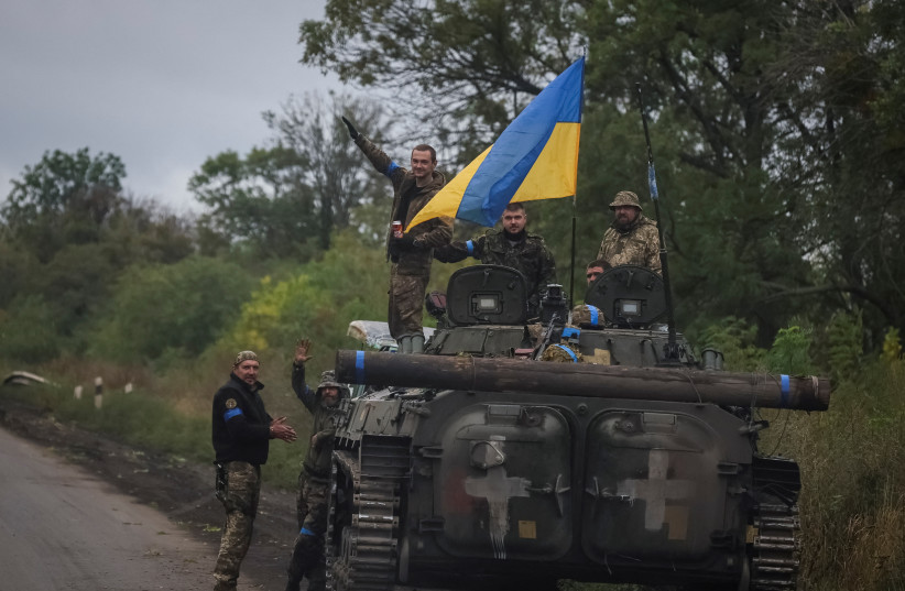  Ukrainian service members stand on a BMP-1 infantry fighting vehicle, amid Russia's attack on Ukraine, near the town of Izium, recently liberated by Ukrainian Armed Forces, in Kharkiv region, Ukraine September 14, 2022. (photo credit: GLEB GARANICH/REUTERS)