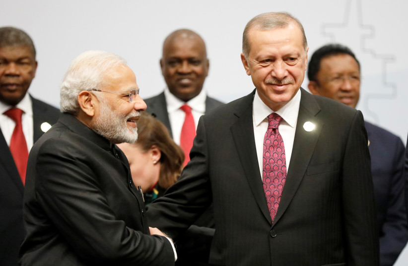 Turkey's President Tayyip Erdogan and Indian Prime Minister Narendra Modi greet before they pose for a group picture at the BRICS summit meeting in Johannesburg, South Africa, July 27, 2018. (photo credit: REUTERS/MIKE HUTCHINGS)